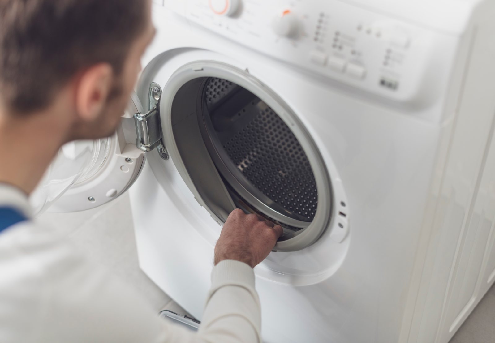 Technician inspecting a washing machine